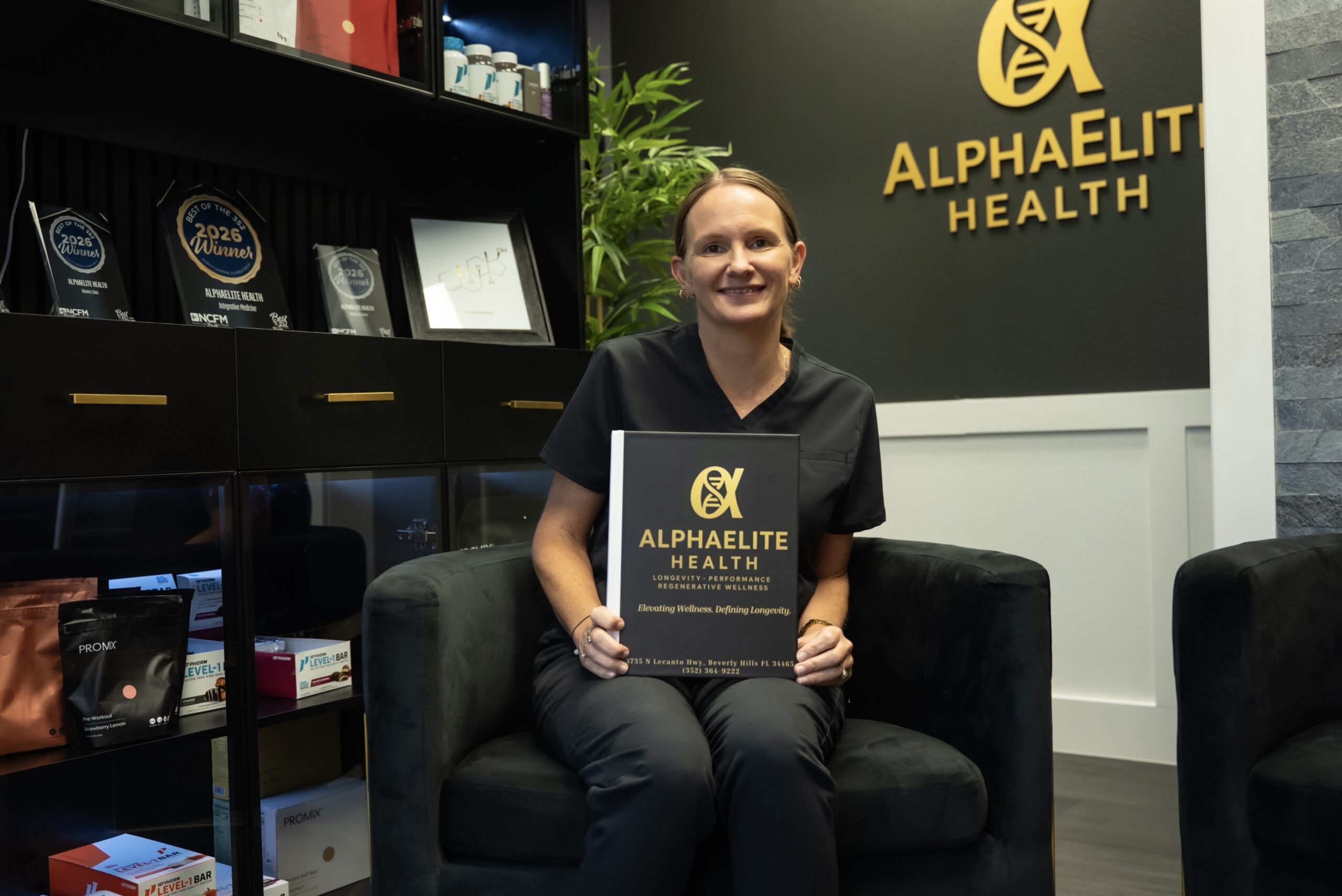 AlphaElite Health team member in the branded clinic reception area